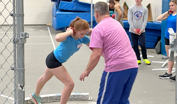 Shotput teacher and student